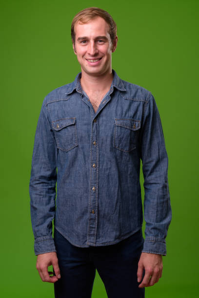 istock Young man against green background 996958266