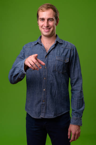 istock Young man against green background 996964222
