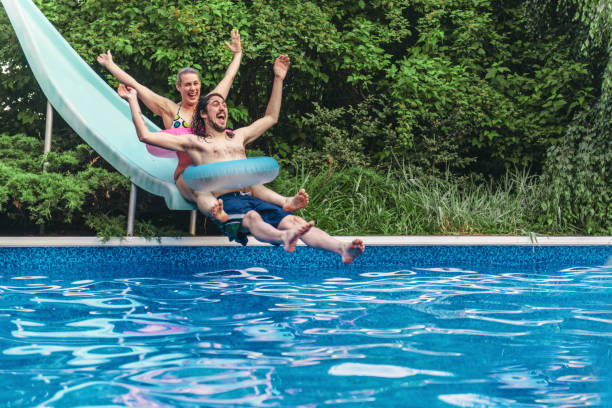 Couple having fun in a swimming pool during summer day
