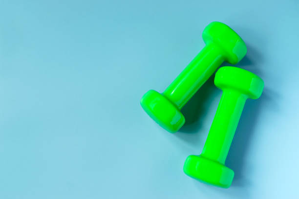 istock Top view dumbbells with measuring for diet or sport exercise concept on blue background. 996964528