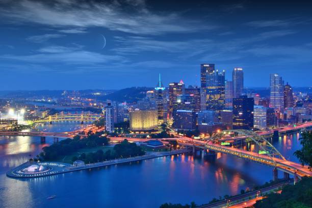 istock Illuminated City By River Against Sky At Night 996966596