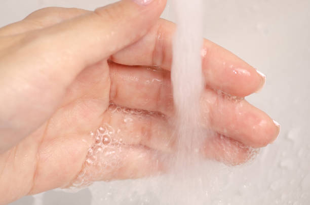 istock Water in the washbasin bathroom female hand 996970432