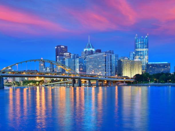 istock Illuminated Bridge Over River By Buildings Against Sky 996970654
