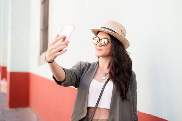 istock Young hispanic woman taking a selfie 996974204