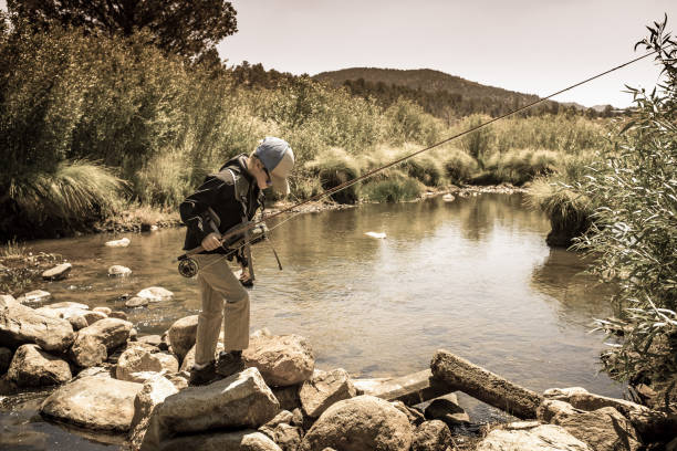 istock 8 Year Old Boy Fly Fishing 996975756