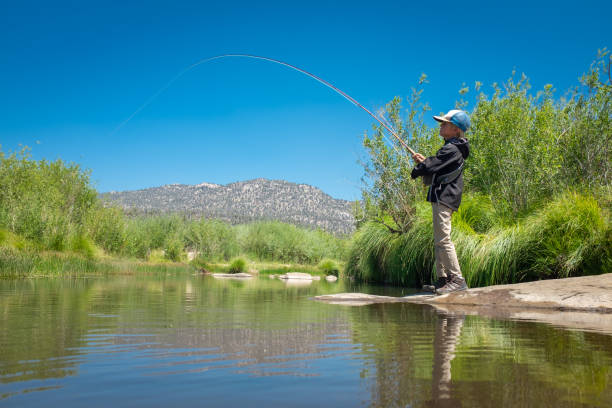 istock 8 Year Old Boy Fly Fishing 996975890