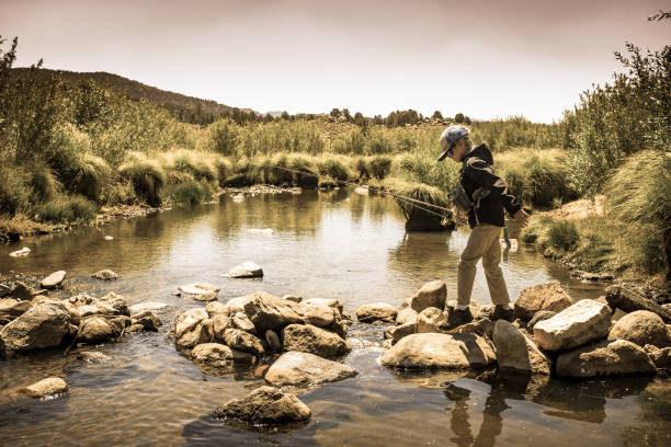 istock 8 Year Old Boy Fly Fishing 996976160