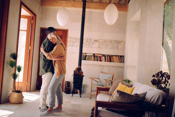 istock Affectionate mature retired couple with problems embracing at home 996983768