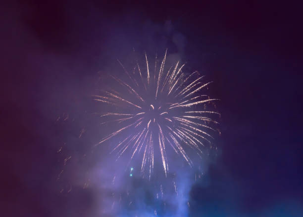 istock blue smoke and white fireworks in night sky to celebrate event 996985842