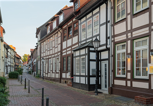 Alley in old town with traditional half-timbered houses in town of pied piper, Hameln, Lower Saxony, Germany at dusk