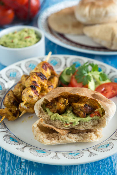 istock Chicken skewer with pita bread, avocado dip and salad 996989774