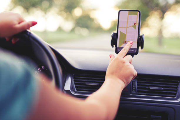 istock Female driver uses navigation on his mobile phone 996990820