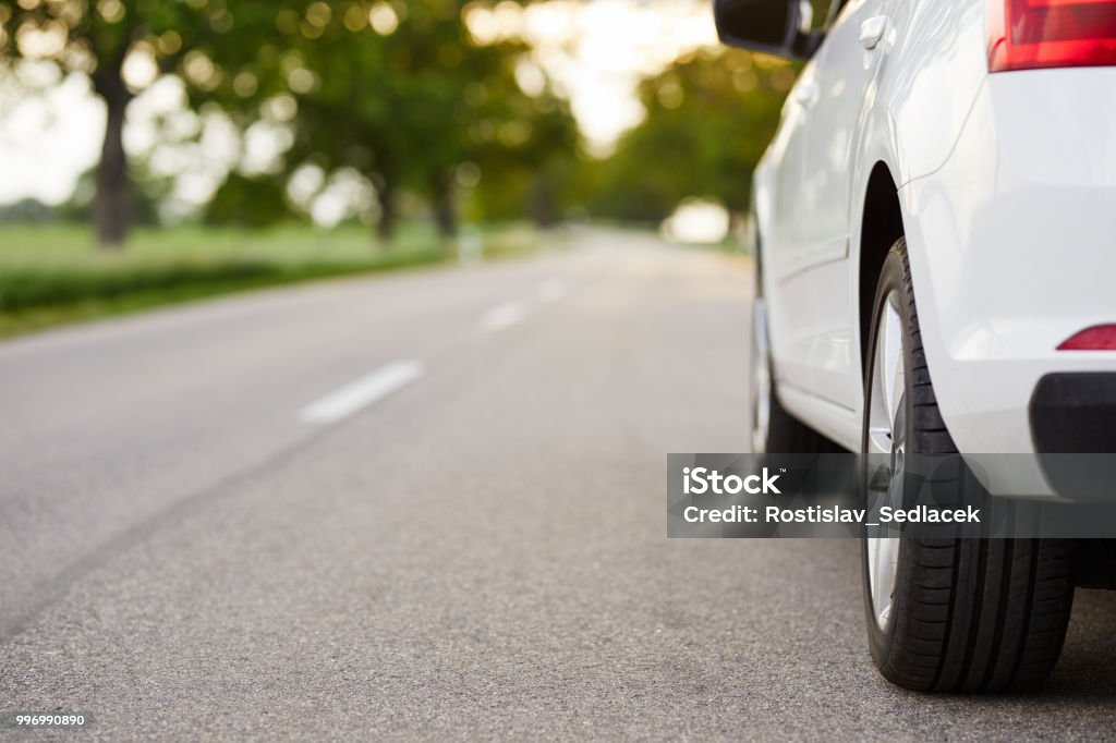 White car standing on the road White car standing on the road with copy space Car Stock Photo