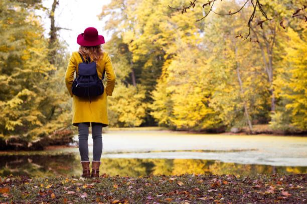 istock Beautiful woman tourist with backpack in park. 996994010