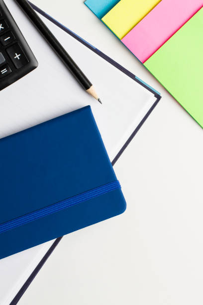 istock Agenda and notebook with pencil, calculator and notepad on white background. 996999288