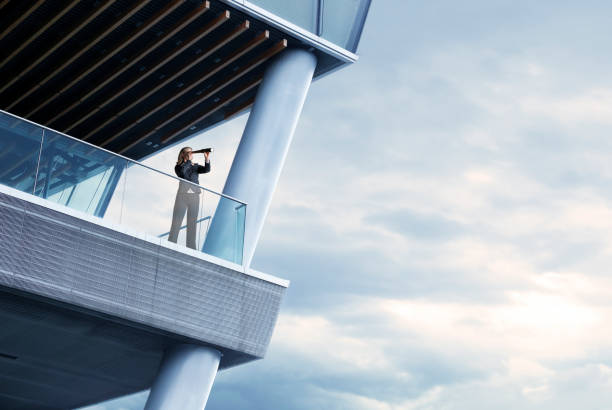 istock Businesswoman Looking Through Spyglass 997003104
