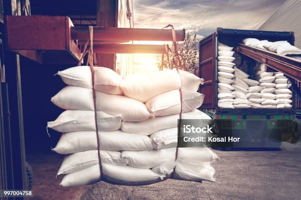 Forklift Handling White Sugar Bags Stuffing Into A Container Truck Stock Photo - Download Image Now