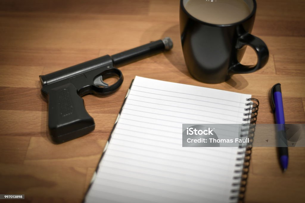 Gun and notepad Assassination Stock Photo