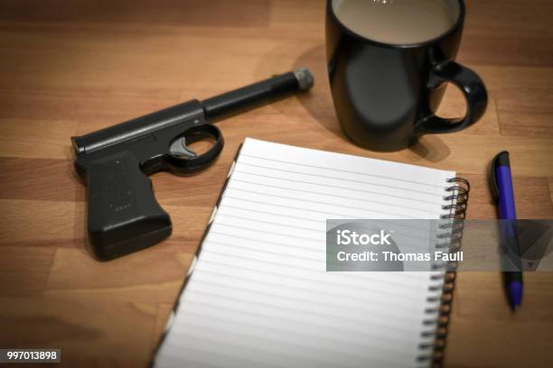 Gun And Notepad Stock Photo - Download Image Now - Assassination, Ballpoint Pen, Concepts