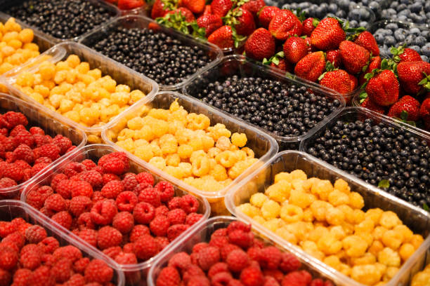 istock Colourful mix of different fresh berries at market 997014140