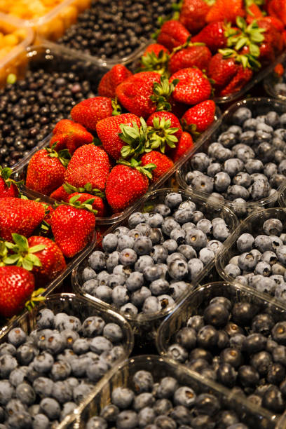 istock Colourful mix of different fresh berries at market 997014284