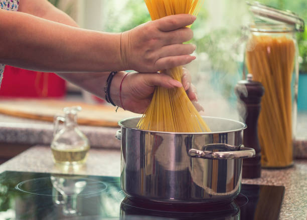 istock Young Women Cooking Spaghetti 997014522