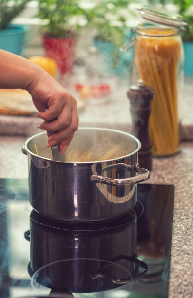 istock Young Women Cooking Spaghetti 997017498