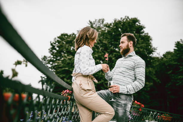 Young Couple Enjoying Romantic Anniversary On Balcony