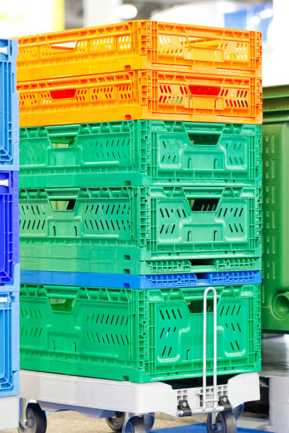 istock colorful plastic boxes stacked one upon the other on warehouse trolley or platform trolley 997023812