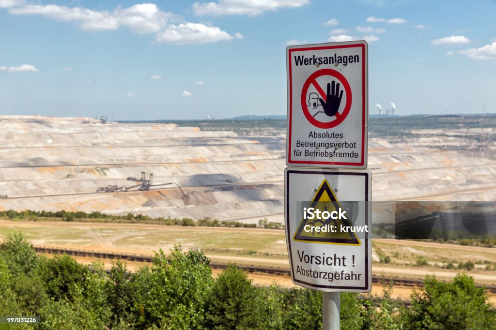 Warning sign near open pit mine Hambach in Germany Warning sign near open pit mine Hambach with brown coal digging in Germany Aerial View Stock Photo