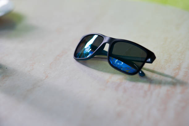 istock Sunglasses on Wooden Surface 997055074