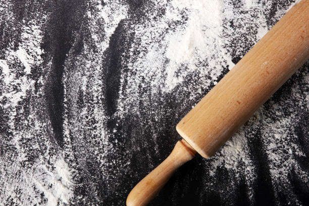 istock Baking background with the rolling pin with flour. On the dark table. Free space for text 997071316
