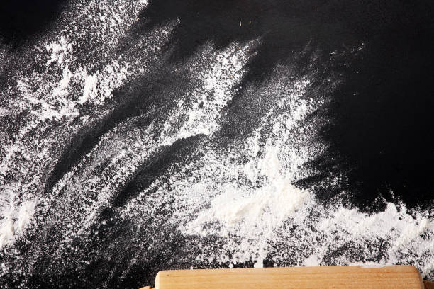 istock Baking background with the rolling pin with flour. On the dark table. Free space for text 997071454