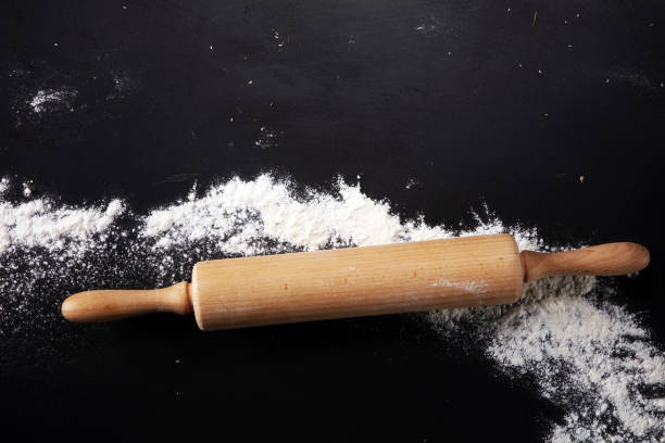 istock Baking background with the rolling pin with flour. On the dark table. Free space for text 997071822
