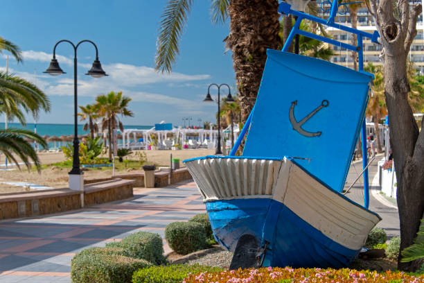 Torremolinos Old blue fishing boat on the beach promenade in Torremolinos, Andalusia, Spain. torremolinos beach stock pictures, royalty-free photos & images