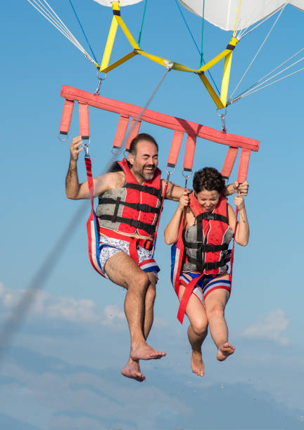 istock Lovely couple during parasailing 997082626