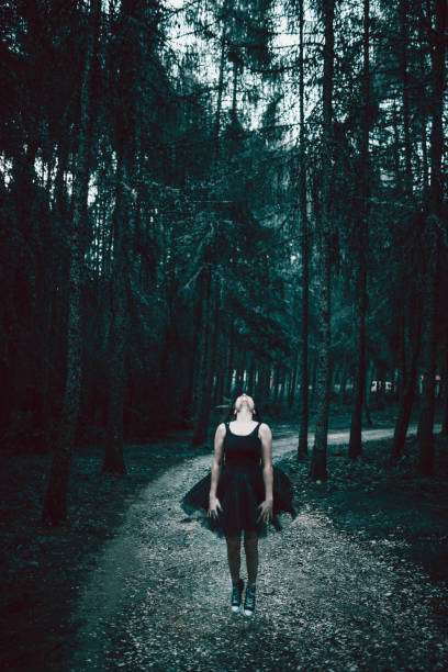 istock Attractive Female Jumping In Forest During Sunset 997088266