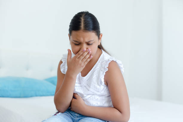istock Young Girl On Bed Feeling Nauseous 997090786