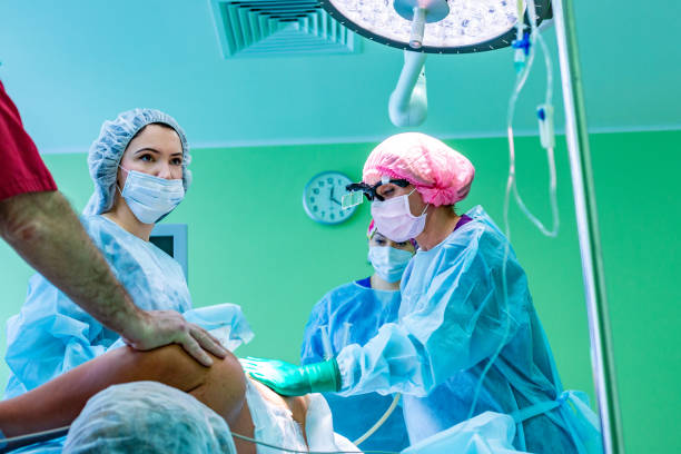 istock cosmetic liposuction surgery in actual operating room setting showing surgeons group during operation 997121850