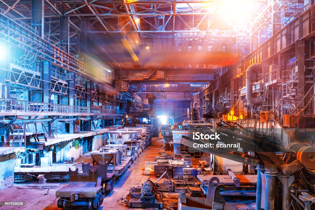 Interior of metallurgical plant workshop Interior of metallurgical plant industrial workshop with open hearth furnace and heavy industry manufacturing equipment Industry Stock Photo