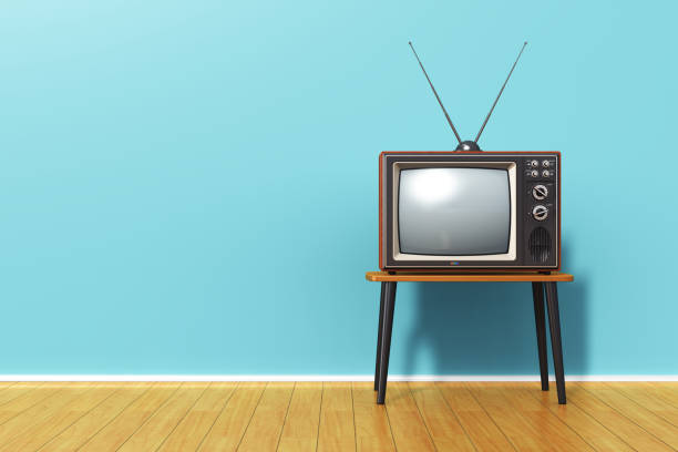 Old retro TV against blue vintage wall in the room Creative abstract 3D render illustration of the old retro TV television set with antenna on table against blue vintage wall background and wooden plank floor in the room bandwidth photos stock pictures, royalty-free photos & images