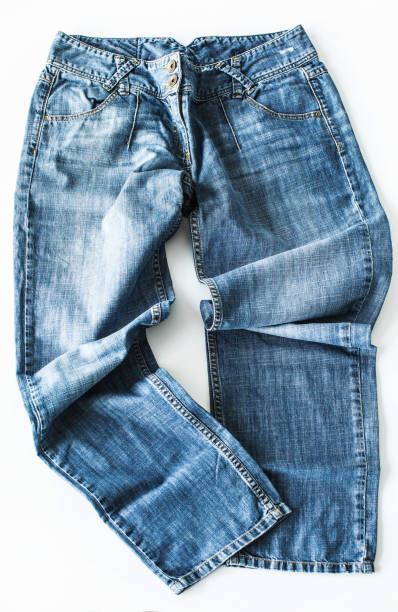 istock Blue jeans lying on the floor isolated 997127454