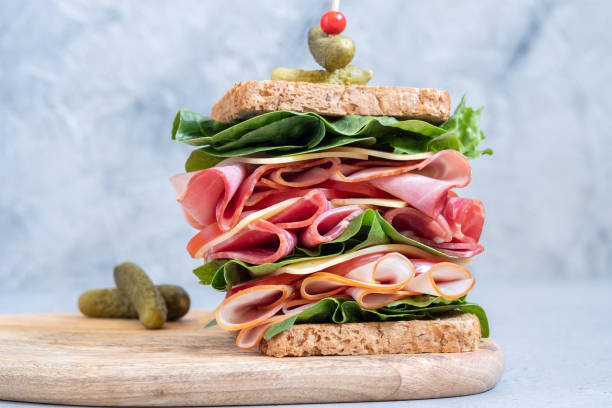 istock Big sandwich with ham, deli meat and vegetables 997136042