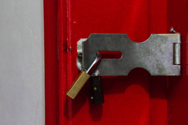 istock Padlock in a red wood door 997136984