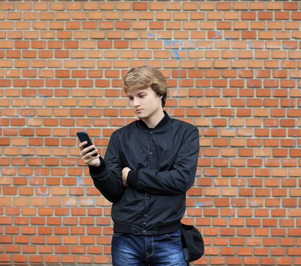 istock Teenage boy typing text message.Using smart phone. 997138678