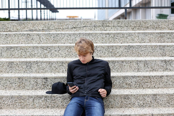 istock Teenage boy typing text message.Using smart phone. 997138810