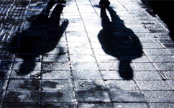istock Blurry shadow and silhouette of two men standing in the night 997147602