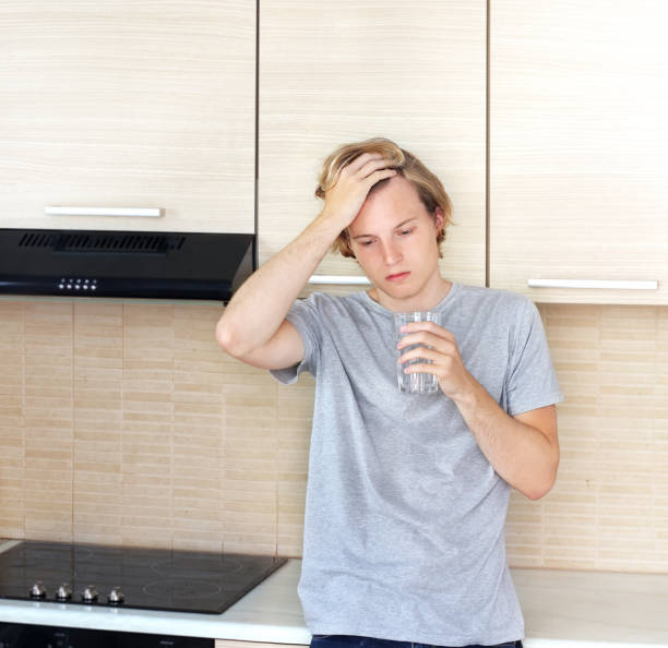 istock Teenager depressed  standing in the kitchen 997150010