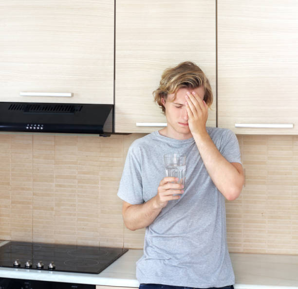 istock Teenager depressed  standing in the kitchen 997150014