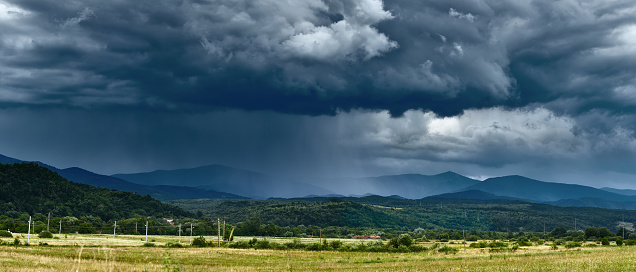 Landscape with curtains of torrential heavy rain in the mountains